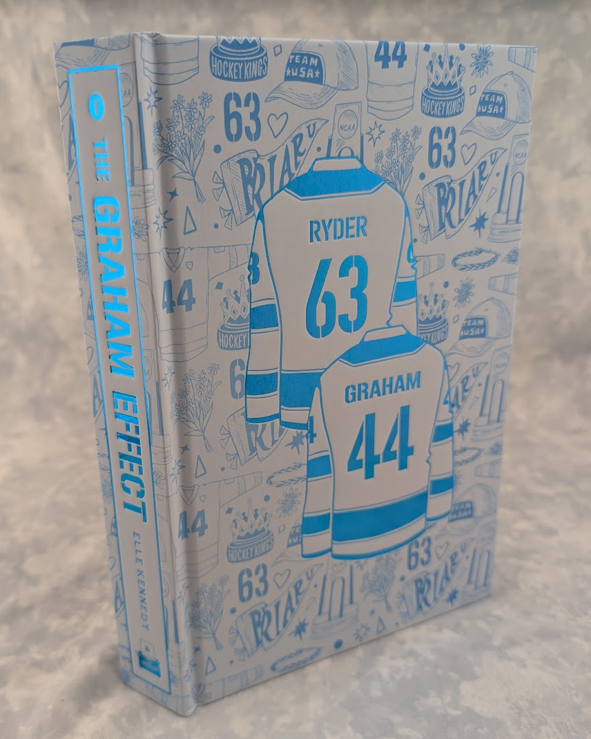 A hardcover book titled 'The Graham Effect', featuring a light blue and white hockey-themed cover with illustrated jerseys, numbers 63 and 44, and doodled icons like hats and trophies.