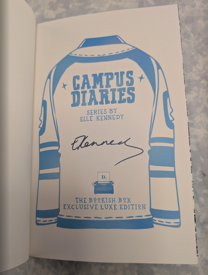 A close-up of a book's interior page featuring a blue and white illustrated sports jersey design with the text 'CAMPUS DIARIES' and a black autograph on an off-white page.